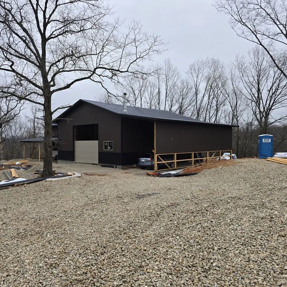 House shell under construction with roof and exterior walls in place