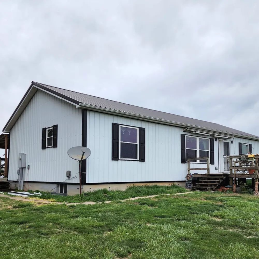 House finished with white metal siding